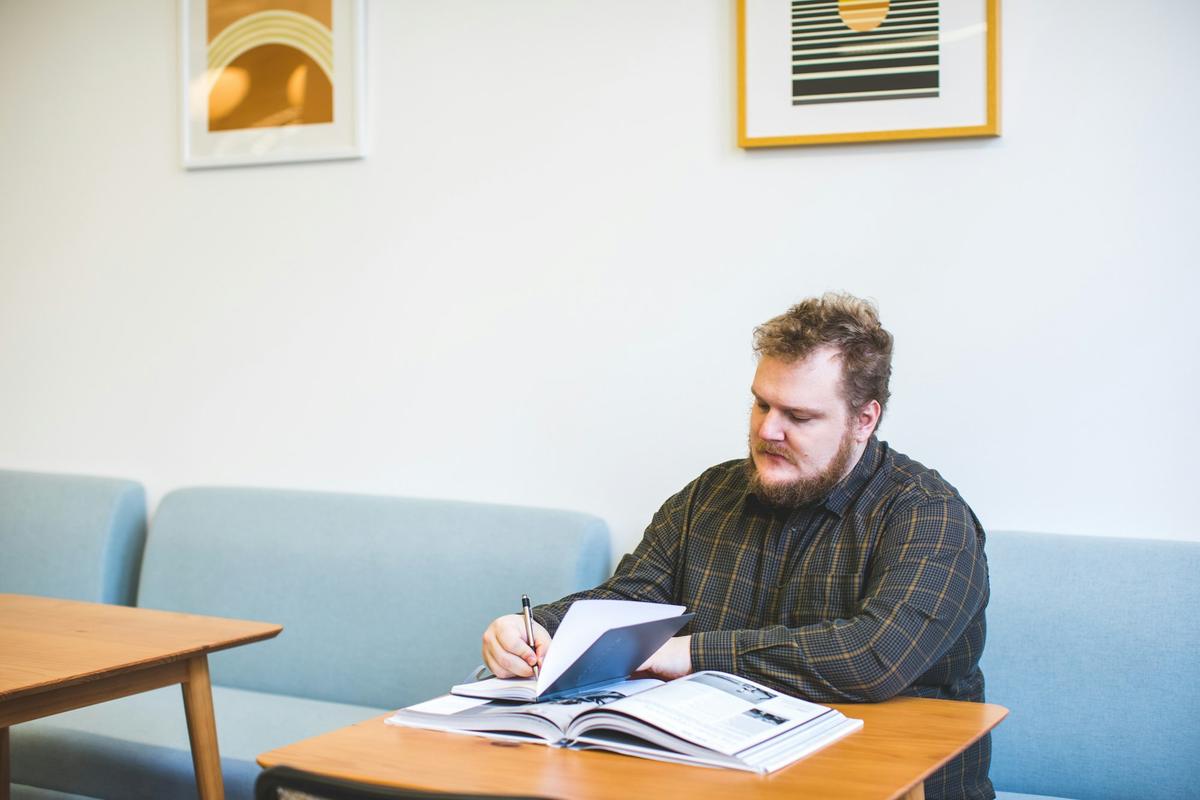 A man studying with a notebook at home