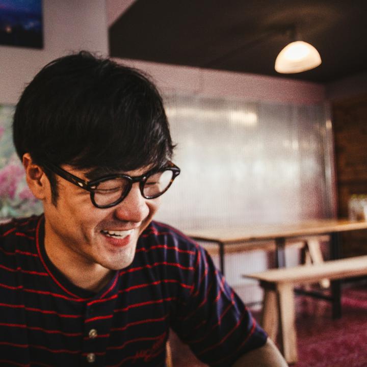 A man in glasses smiling